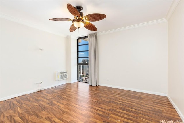 spare room featuring an AC wall unit, ornamental molding, a ceiling fan, wood finished floors, and baseboards