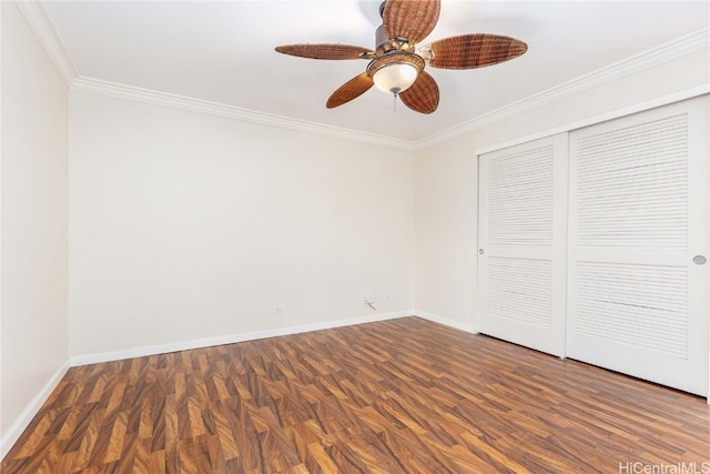 unfurnished bedroom featuring crown molding, ceiling fan, baseboards, wood finished floors, and a closet