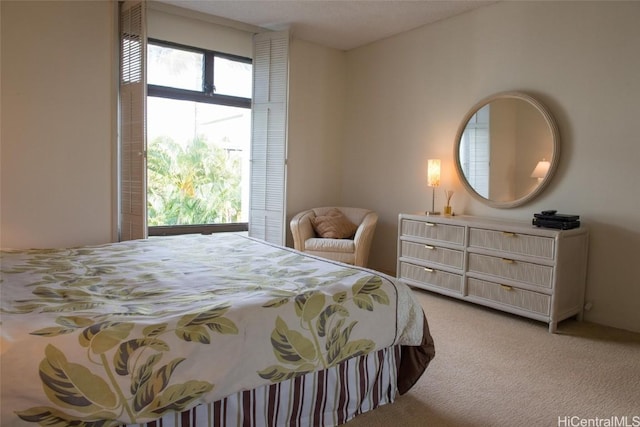 bedroom featuring light carpet