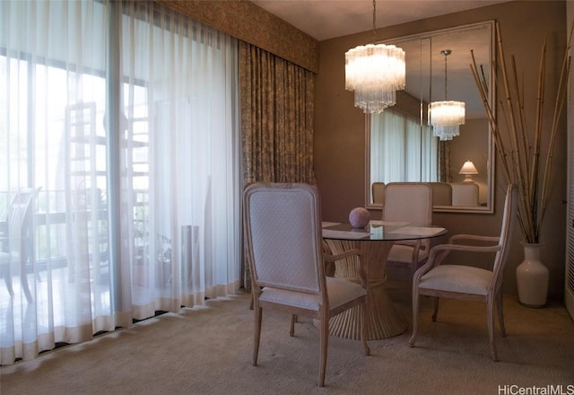 carpeted dining area featuring a chandelier