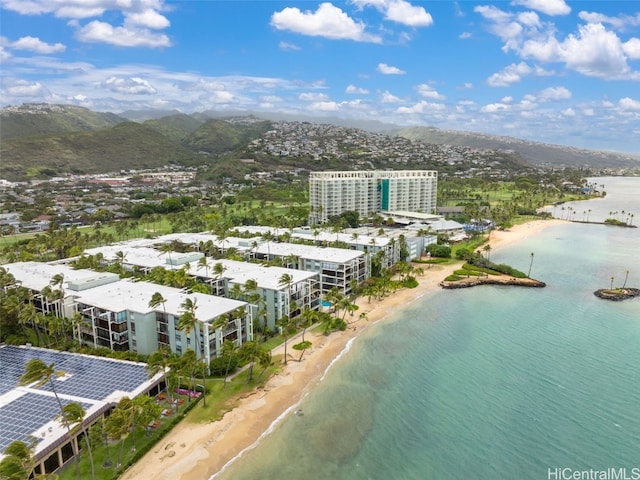 birds eye view of property with a water view and a view of the beach