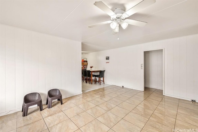 interior space featuring light tile patterned flooring and a ceiling fan