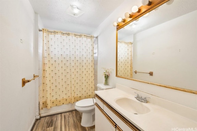 full bath with a textured ceiling, toilet, vanity, and wood finished floors