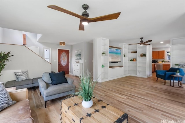 living area with light wood-style flooring, recessed lighting, and a ceiling fan