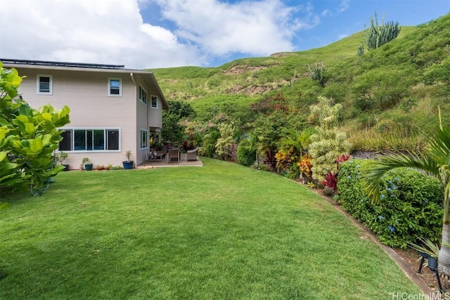 view of yard with a patio and a mountain view