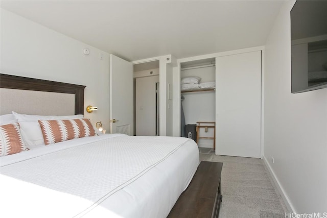 carpeted bedroom with a closet and baseboards