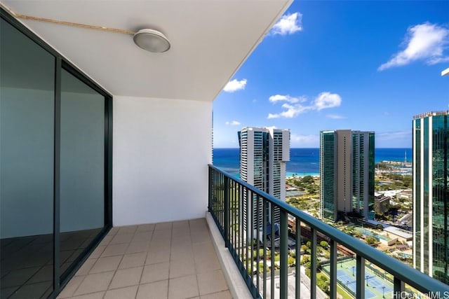 balcony featuring a city view and a water view