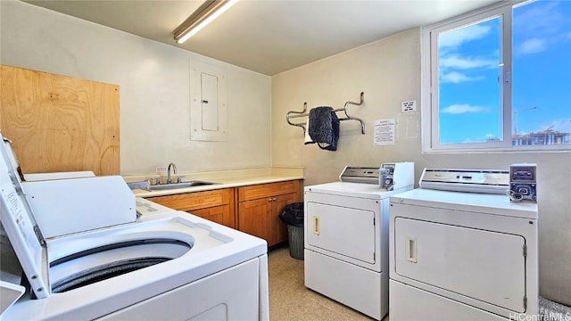 laundry room featuring cabinet space, independent washer and dryer, and a sink