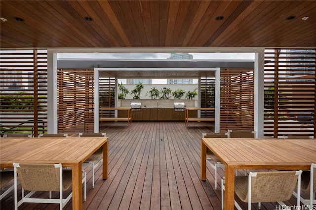 wooden deck featuring grilling area and outdoor dining area