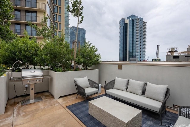 view of patio / terrace featuring an outdoor living space, a view of city, and grilling area