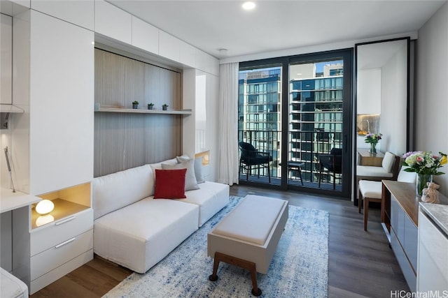 living area featuring floor to ceiling windows and wood finished floors