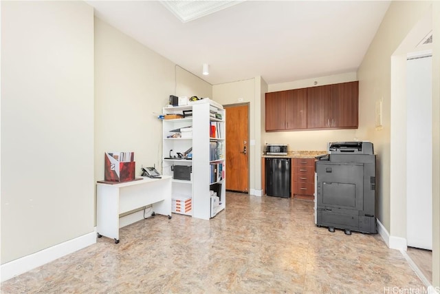 kitchen featuring visible vents, brown cabinets, washer / clothes dryer, light countertops, and baseboards