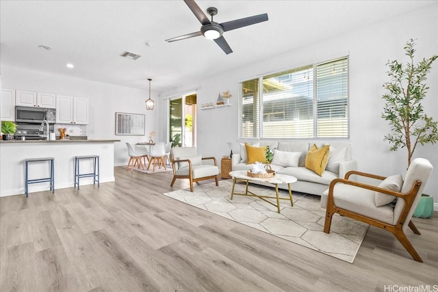 91-6221 Kapolei Pkwy Unit 201, Ewa Beach, HI 96706 - living room featuring light wood finished floors, ceiling fan, and recessed lighting
