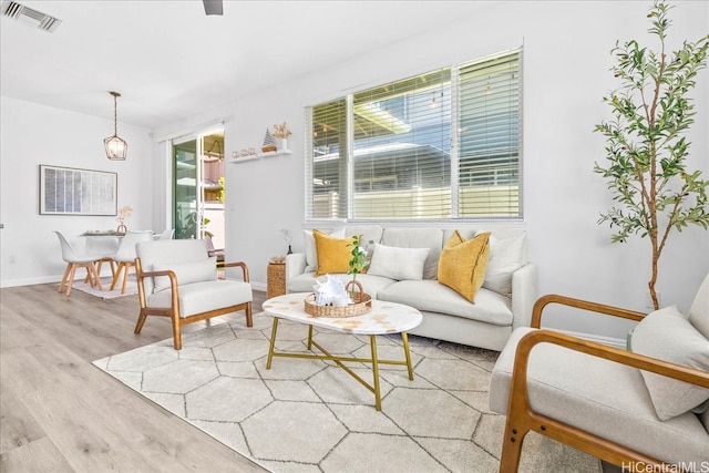 91-6221 Kapolei Pkwy Unit 201, Ewa Beach, HI 96706 - living area featuring plenty of natural light, wood finished floors, and baseboards