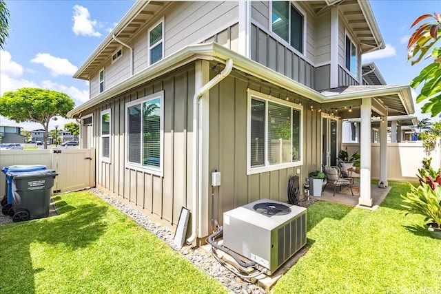 91-6221 Kapolei Pkwy Unit 201, Ewa Beach, HI 96706 - view of home's exterior with board and batten siding, a patio, and central air condition unit