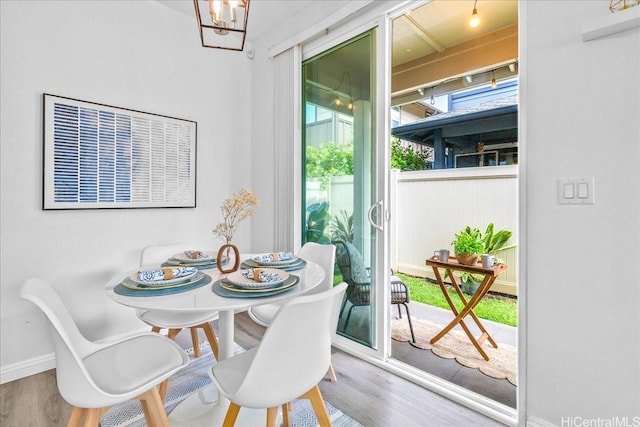 91-6221 Kapolei Pkwy Unit 201, Ewa Beach, HI 96706 - dining space with wood finished floors, baseboards, and a chandelier