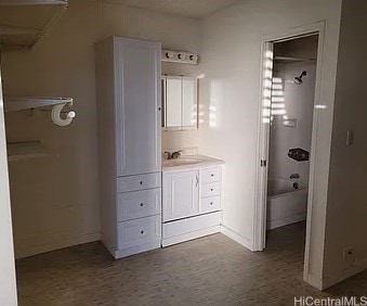 bathroom featuring vanity and  shower combination