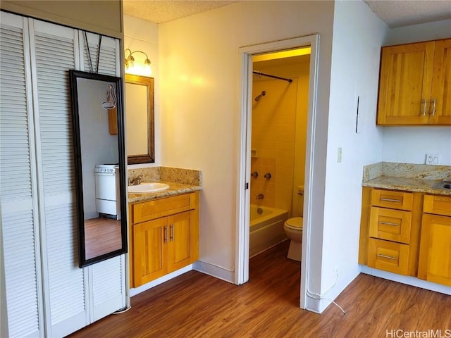 bathroom featuring toilet, vanity, and wood finished floors