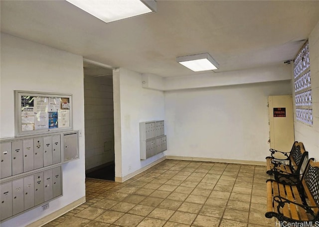 basement with mail area, baseboards, and plenty of natural light