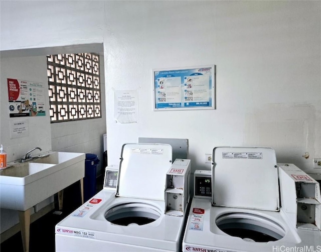 community laundry room featuring a sink and washer and clothes dryer