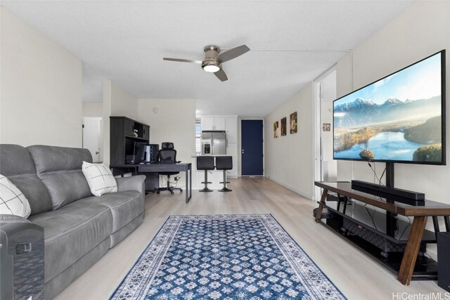 living room with light wood-style floors and ceiling fan