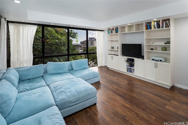 living area featuring recessed lighting, dark wood-type flooring, and built in features