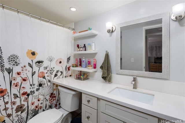 bathroom featuring recessed lighting, toilet, and vanity