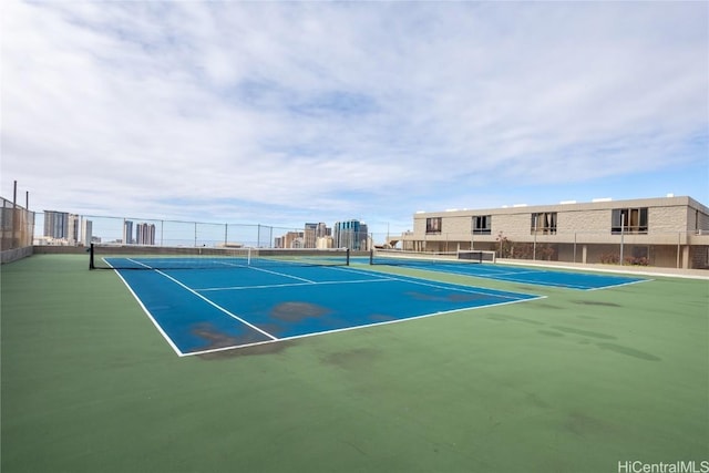 view of tennis court featuring fence