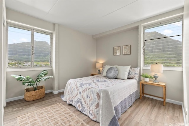 bedroom featuring light wood-type flooring and baseboards