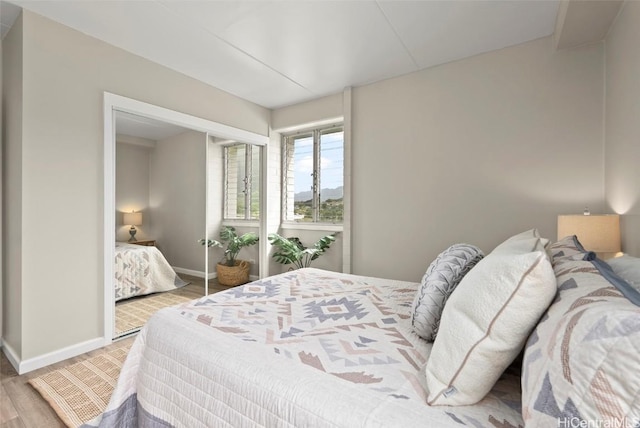 bedroom featuring baseboards and wood finished floors