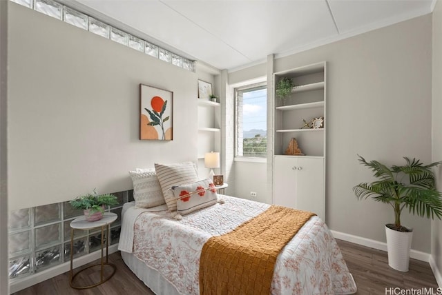 bedroom with wood finished floors and baseboards