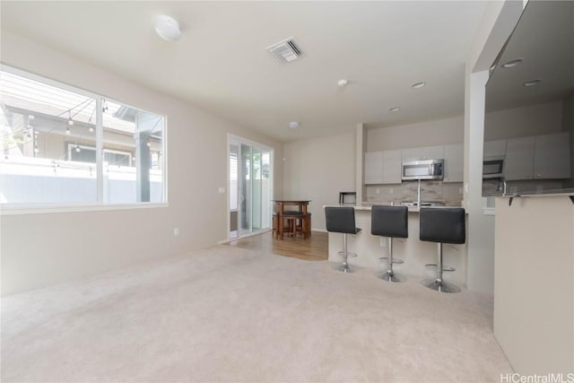 interior space with visible vents and light colored carpet