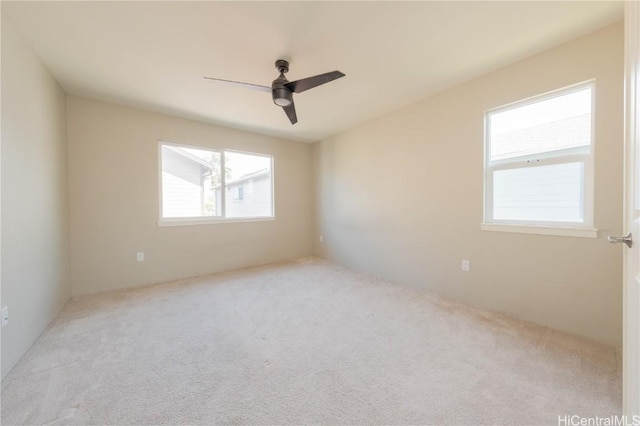 carpeted spare room with ceiling fan