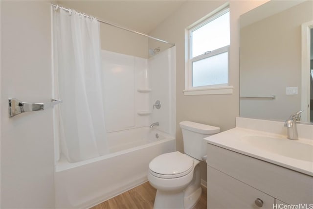 full bath featuring toilet, shower / bath combo with shower curtain, vanity, and wood finished floors