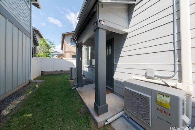 view of yard with ac unit, cooling unit, and fence