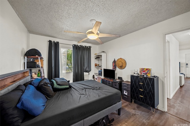 91-1018 Mikohu St Unit 20A, Ewa Beach, HI 96706 - bedroom with ceiling fan, a textured ceiling, and wood finished floors