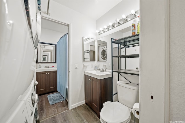 91-1018 Mikohu St Unit 20A, Ewa Beach, HI 96706 - bathroom with toilet, wood finished floors, two vanities, and stacked washer and dryer