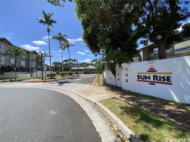 view of street with curbs, sidewalks, and a residential view