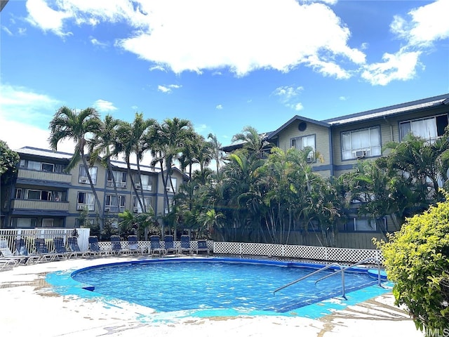 view of swimming pool featuring fence