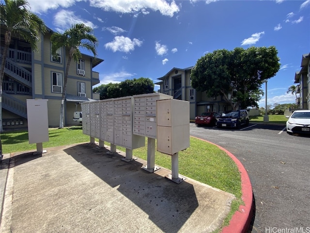 view of community with mail area, a residential view, and uncovered parking