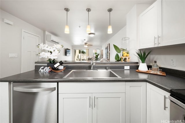 kitchen with dark countertops, white cabinets, dishwasher, and a sink