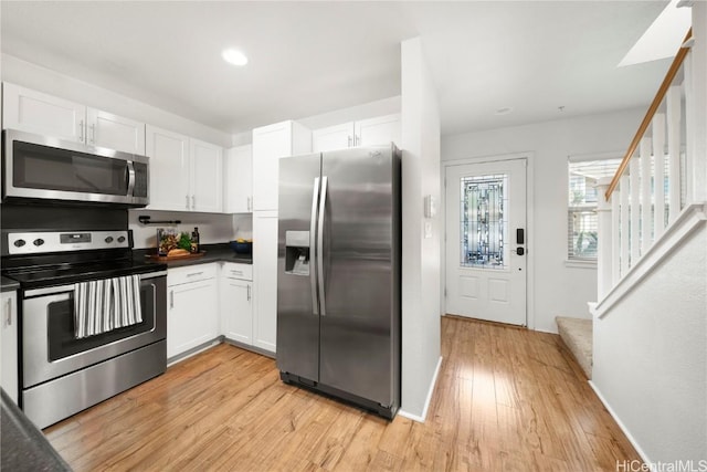 kitchen with white cabinetry, light wood-style floors, and stainless steel appliances