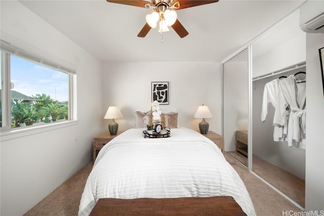 bedroom with a wall mounted air conditioner, a closet, light colored carpet, and ceiling fan