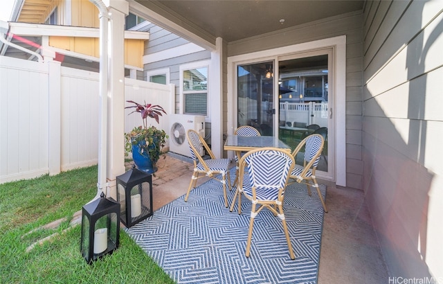 view of patio featuring ac unit and fence