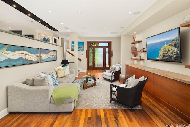 living area with stairway, recessed lighting, wood finished floors, and baseboards