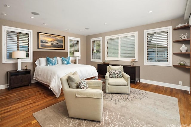 bedroom with recessed lighting, wood finished floors, and baseboards