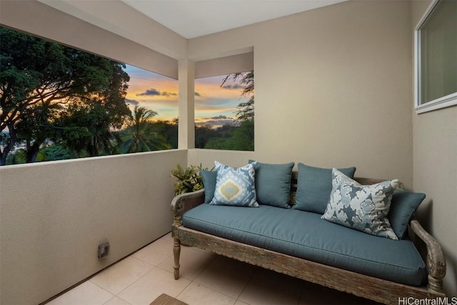 balcony at dusk featuring an outdoor hangout area