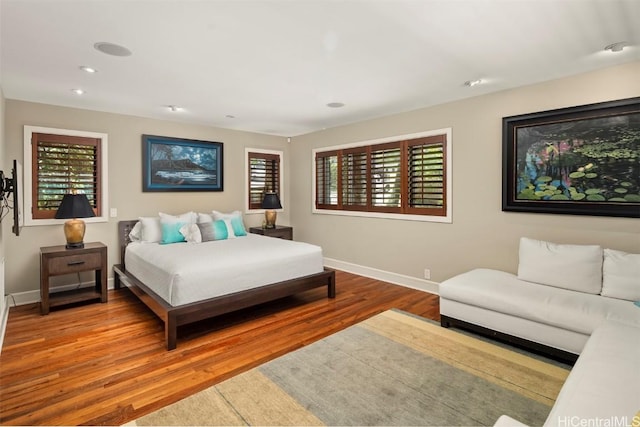 bedroom featuring recessed lighting, wood finished floors, and baseboards