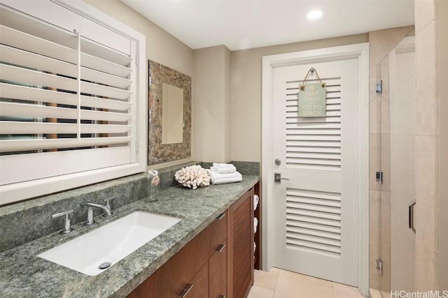 full bathroom with recessed lighting, a stall shower, vanity, and tile patterned flooring