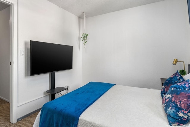 bedroom with carpet and a textured ceiling